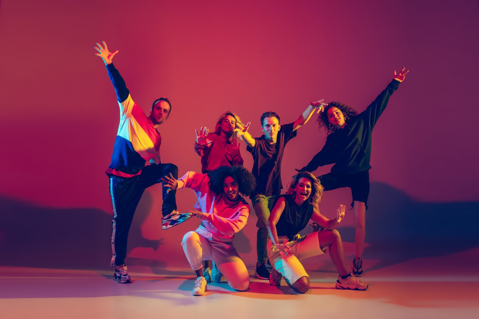 Stylish Men and Woman Dancing Hip-Hop in Bright Clothes on Gradient Background at Dance Hall in Neon Light